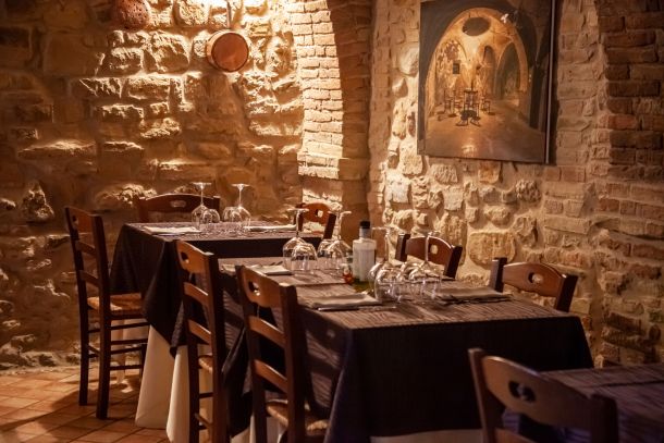 sala interna in pietra con tavoli apparecchiati del ristorante La Tacchinella cucina tipica teramana abruzzese a Canzano